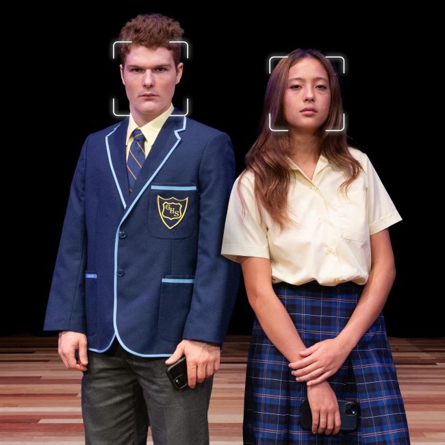 Two high school students are standing on a stage looking at the camera with facial recognition squares over their faces. Promo image for the high school cyberbullying performance Verbal Combat.