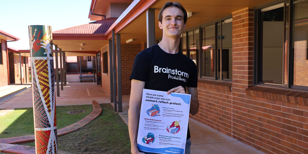 A Brainstorm Productions actor Adam is holding a Safer Internet Day poster